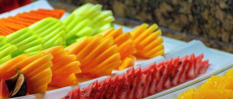 A variety of sliced fruits arranged on a white plate.