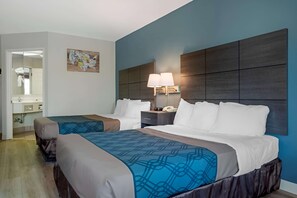 A hotel room with two beds, a nightstand with a lamp, a bathroom visible through an open door, and a wall-mounted artwork. - Americas Best Value Inn Gettysburg (Gettysburg)