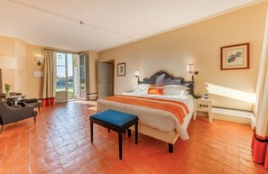 A hotel room with a large bed, a desk, a chair, and a view of the outdoors. - Borgo Scopeto Wine & Country Relais (Castelnuovo Berardenga)
