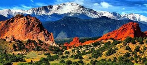 A mountainous landscape with prominent red rock formations and snow-capped peaks in the background. - Days Inn by Wyndham Manitou Springs (Manitou Springs)