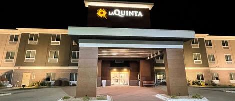 A hotel entrance with a sign reading "La Quinta" and a sun symbol.