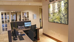 A hotel reception area with a desk, computer, and a large map on the wall. - Holiday Inn Express Hotel & Suites Cape Girardeau I-55 by IHG (Cape Girardeau)