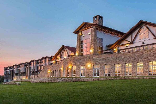 A large, multi-story hotel with a stone facade and multiple windows. - Lied Lodge & Conference Center (Nebraska City)