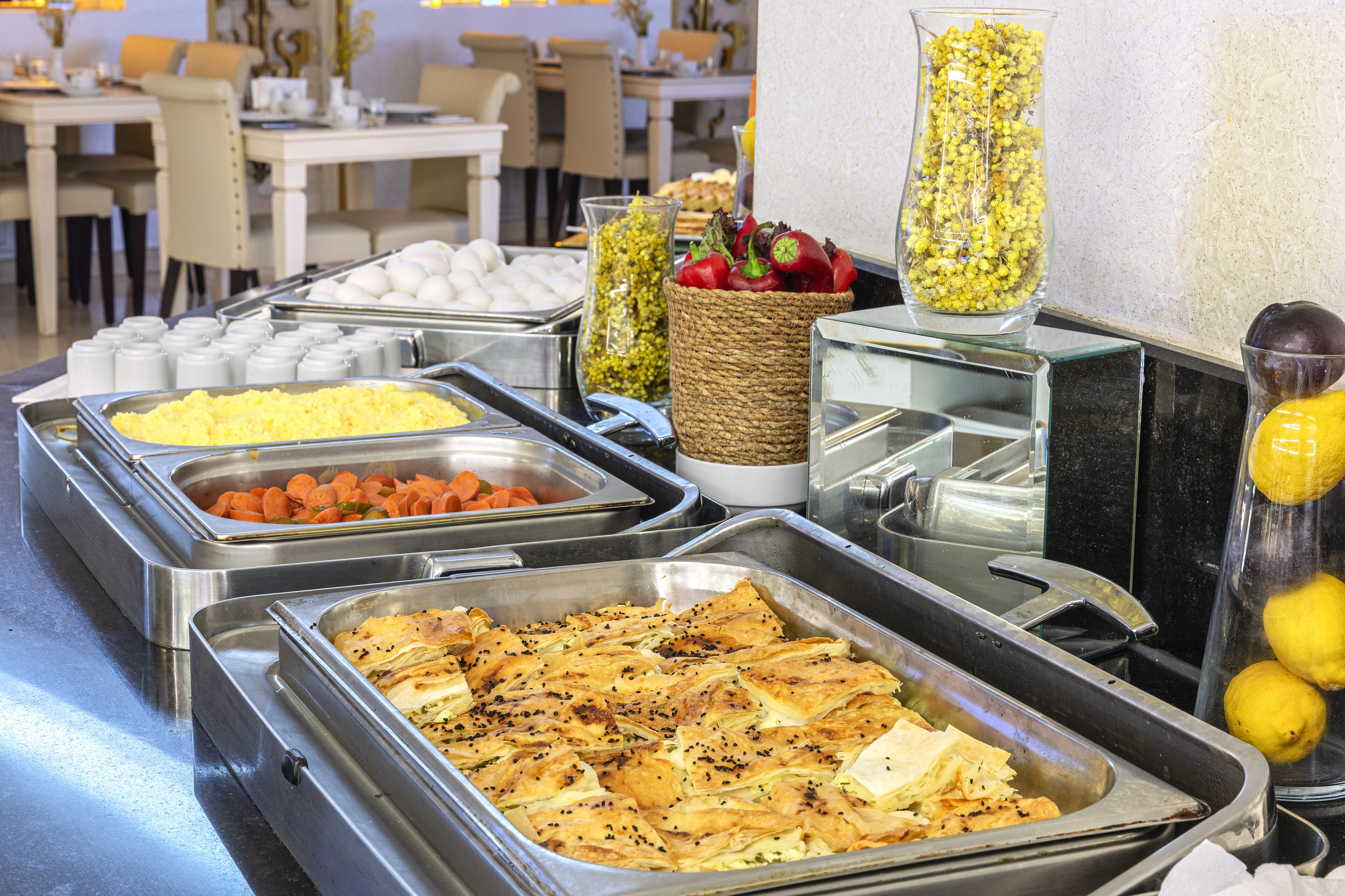 A buffet with various food options including eggs, vegetables, and baked dishes.