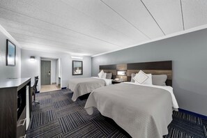 A hotel room with two beds, a desk, and a chair. - Admiralty Inn & Suites - a Red Collection Hotel (East Falmouth)