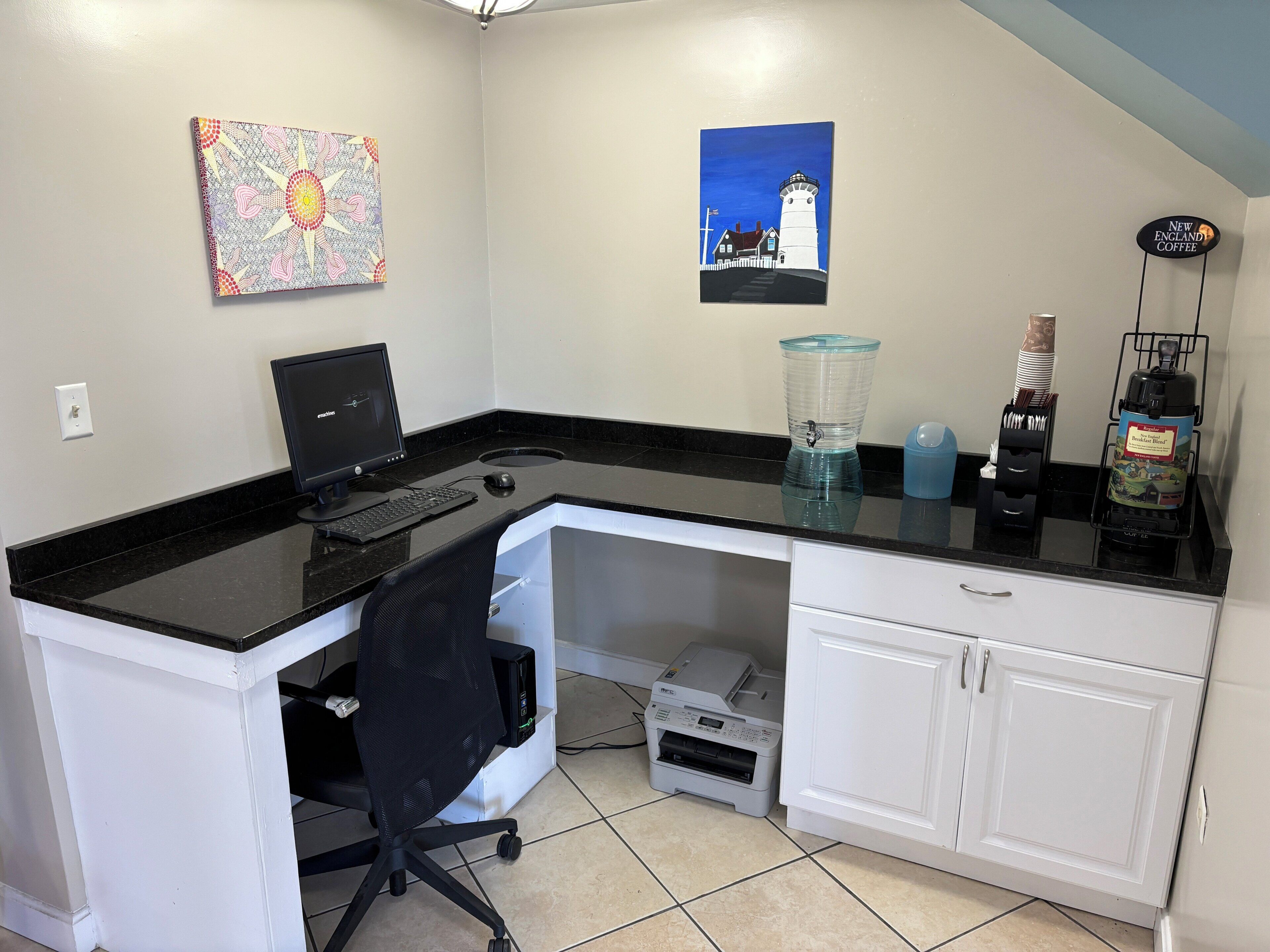 A home office with a desktop computer, a printer, a water dispenser, and a coffee maker.