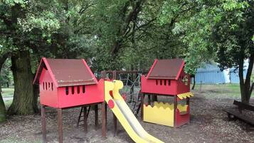 Children can play in the two playhouses with a slide connecting them.