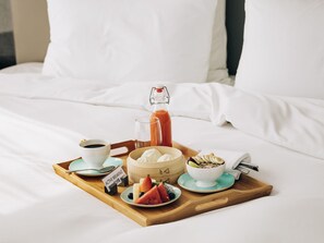 A breakfast tray with coffee, juice, yogurt, and fruit on a bed. - Hotel Oran Bay Managed By Accor (Oran)