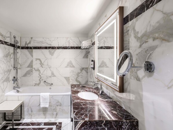A modern bathroom with a bathtub, a sink, and a shower.