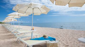 Playa privada, sillas reclinables de playa, sombrillas