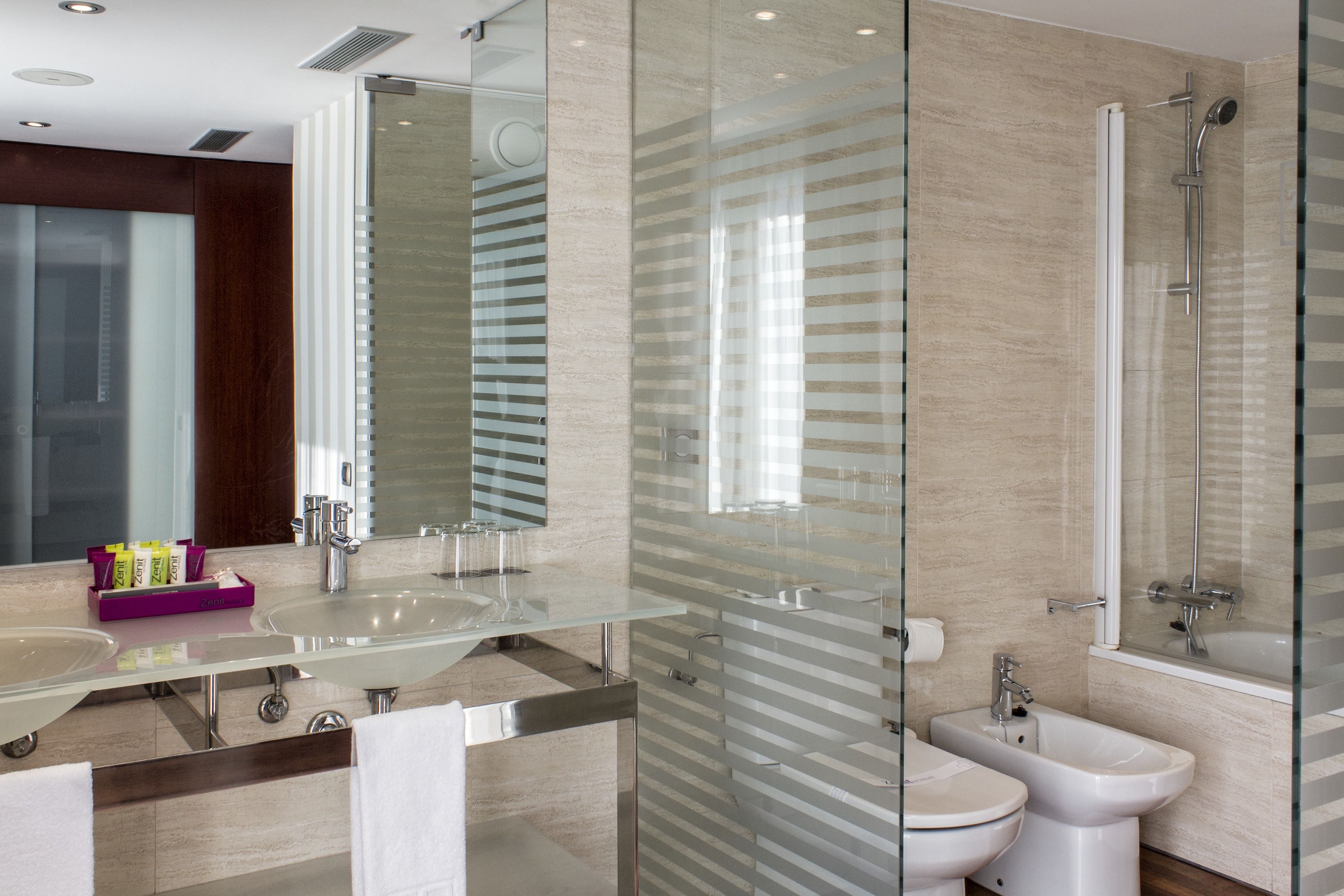 junior suite | bathroom | deep-soaking bathtub, rainfall showerhead, eco-friendly toiletries