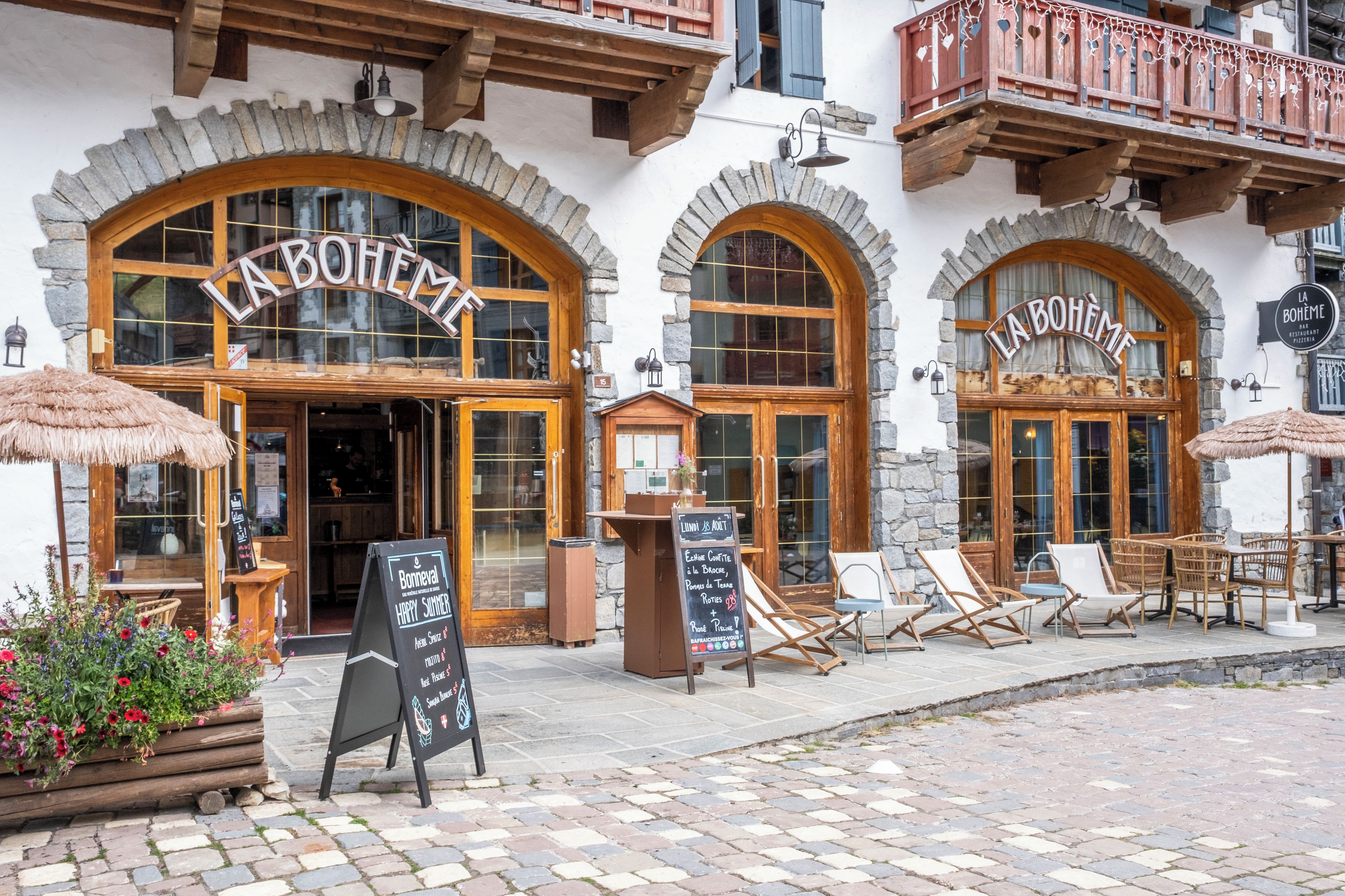 A traditional European-style building with arched windows and wooden balconies.