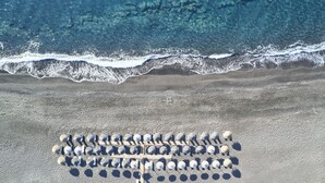 Nær stranden, solsenger, parasoller og strandhåndklær
