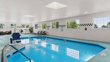 Relax by the pool with a view of the outdoors from the comfort of a seating area.