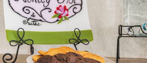 A plate of cookies and a sign with 'Ashley Inn' and 'Fruits' written on it.