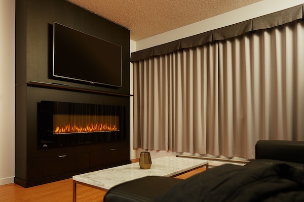Deluxe Suite, 1 King Bed | Living area | 55-inch flat-screen TV with cable channels, TV, computer monitors