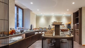 A modern breakfast bar with a variety of food items and a coffee station. - Hotel Raffaello, Sure Hotel Collection by Best Western (Rome)