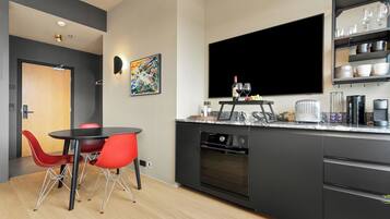 Superior Triple Room | Private kitchen | Fridge, coffee/tea maker, dining tables