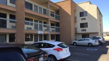 A multi-story parking garage with several cars parked.