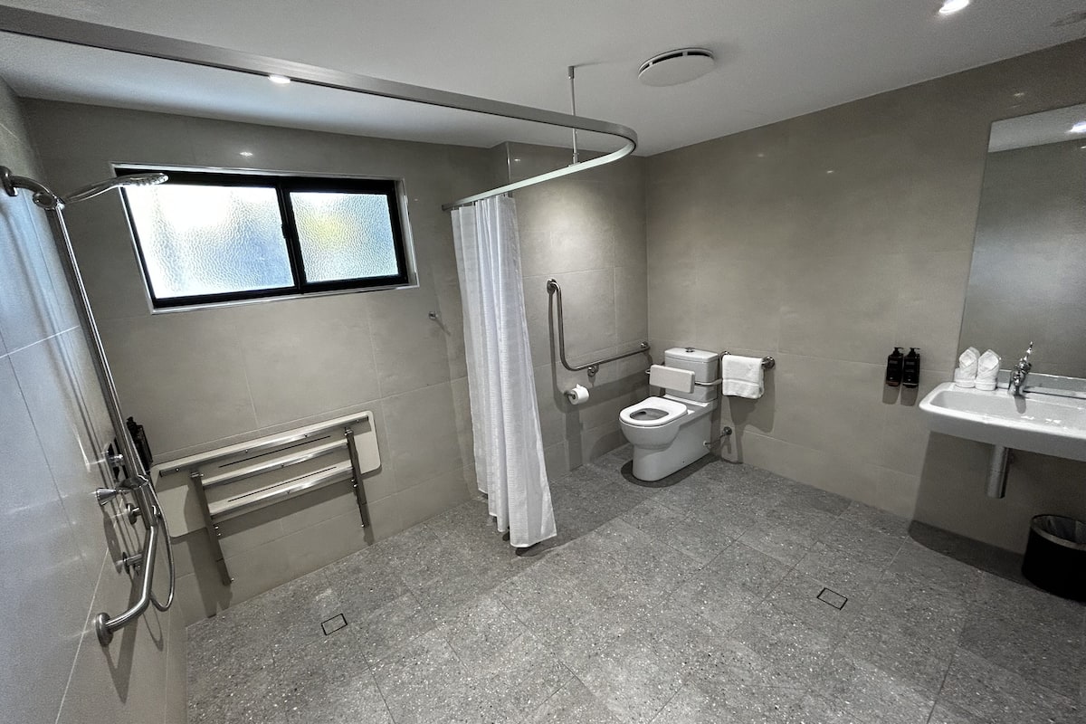 deluxe suite, 1 king bed | bathroom | shower, eco-friendly toiletries, hair dryer, towels