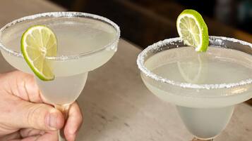 Two margarita glasses with lime garnishes and salt rims.