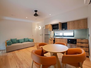 A modern kitchen with wooden cabinets, a built-in oven, and a window above the sink. - Mercure Darwin Airport Resort (Eaton)