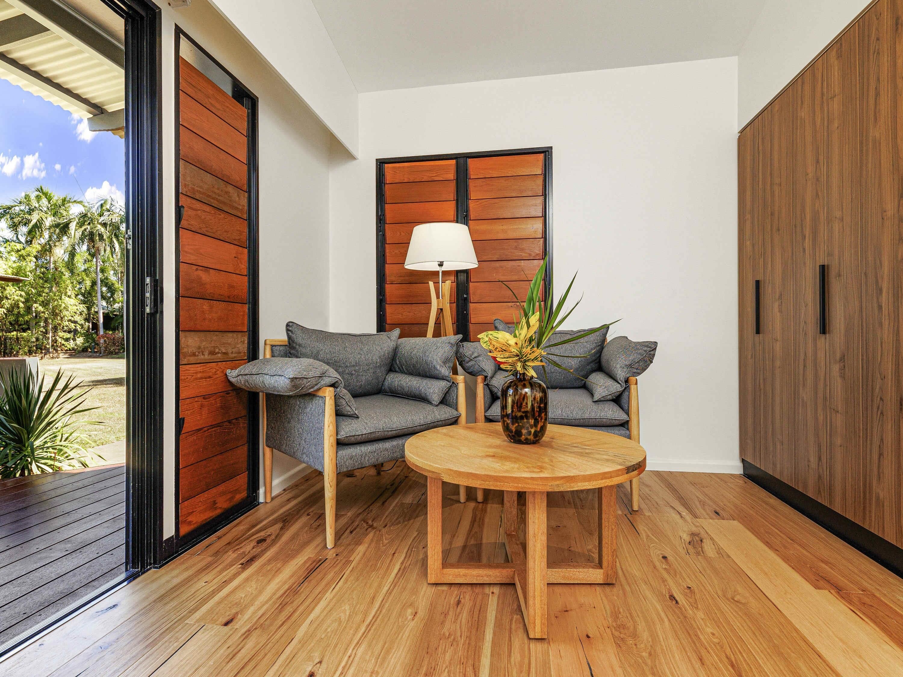 A modern interior with a grey sofa, a wooden coffee table, and a lamp.