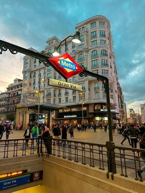 A busy urban square with a Metro sign, a McDonald's restaurant, and a large building with classical architecture. - ibis Styles Madrid Maravillas (Madrid)