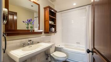 A bathroom with a sink, toilet, and bathtub.