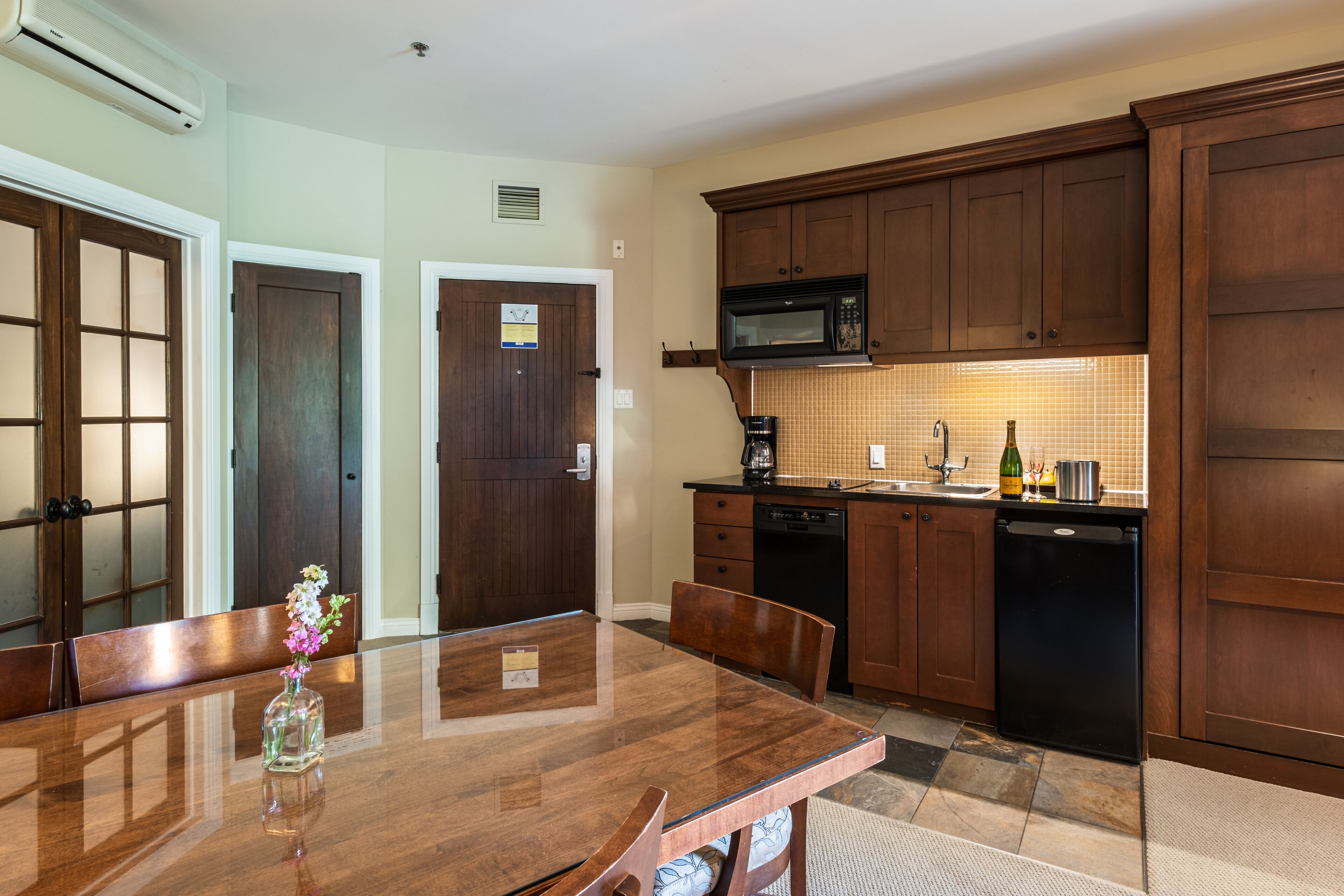 A modern kitchen with wooden cabinets, a microwave, and a dishwasher.