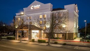 A Comfort Suites hotel with a prominent sign, a covered entrance, and a well-lit facade. - Comfort Suites Clovis - Fresno (Clovis)