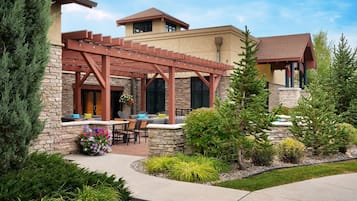 A house with a patio area featuring outdoor furniture and a pergola.