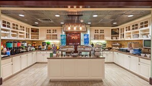A spacious kitchen with a central island, equipped with various appliances and a large window for natural light. - Homewood Suites by Hilton Wichita Falls (Wichita Falls)