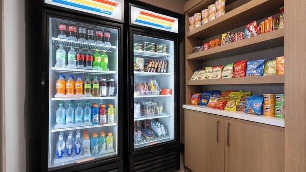 A refrigerated display case with various beverages and snacks. - Holiday Inn Express Charlotte West - Gastonia by IHG. (Gastonia)