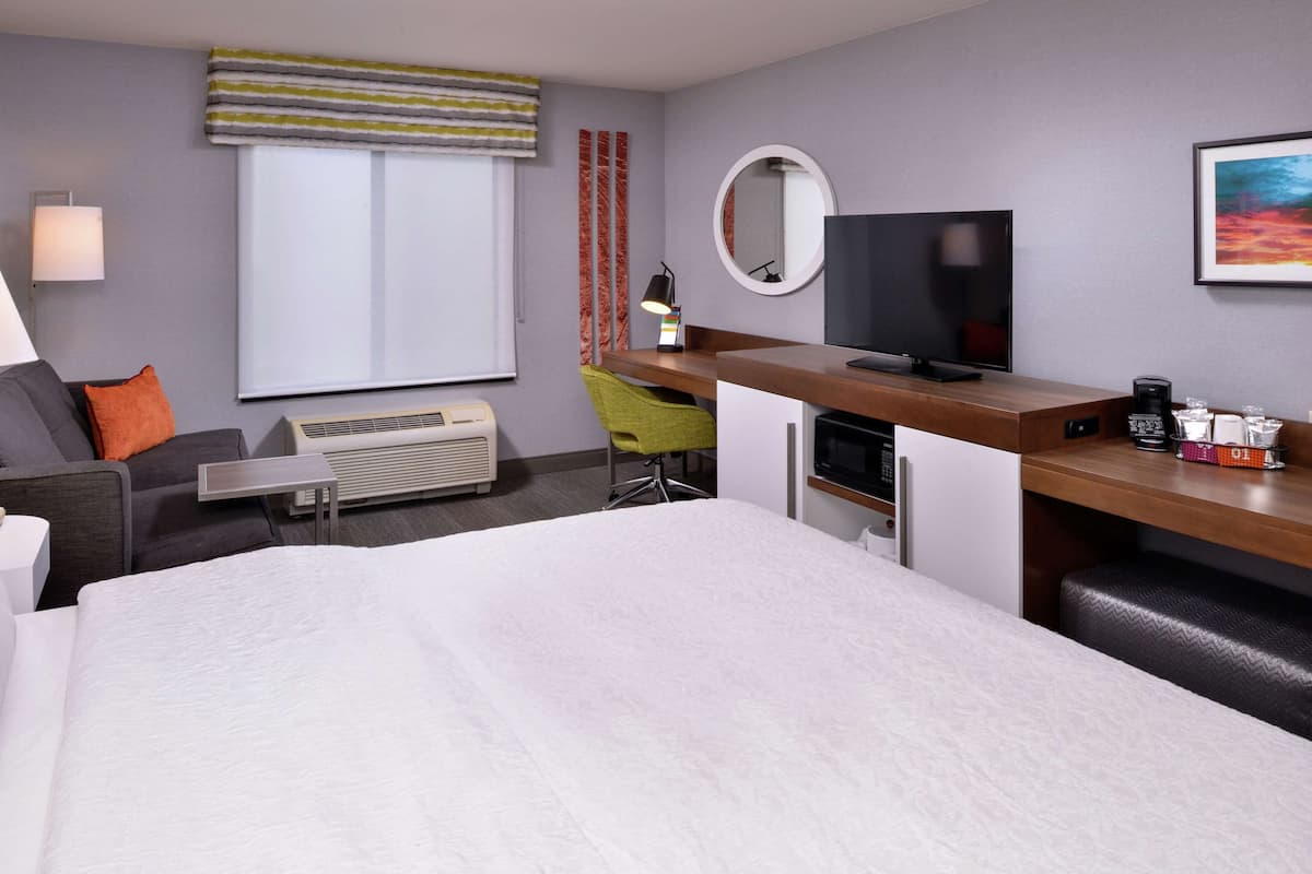 Hypo-allergenic bedding, desk, laptop workspace, blackout curtains