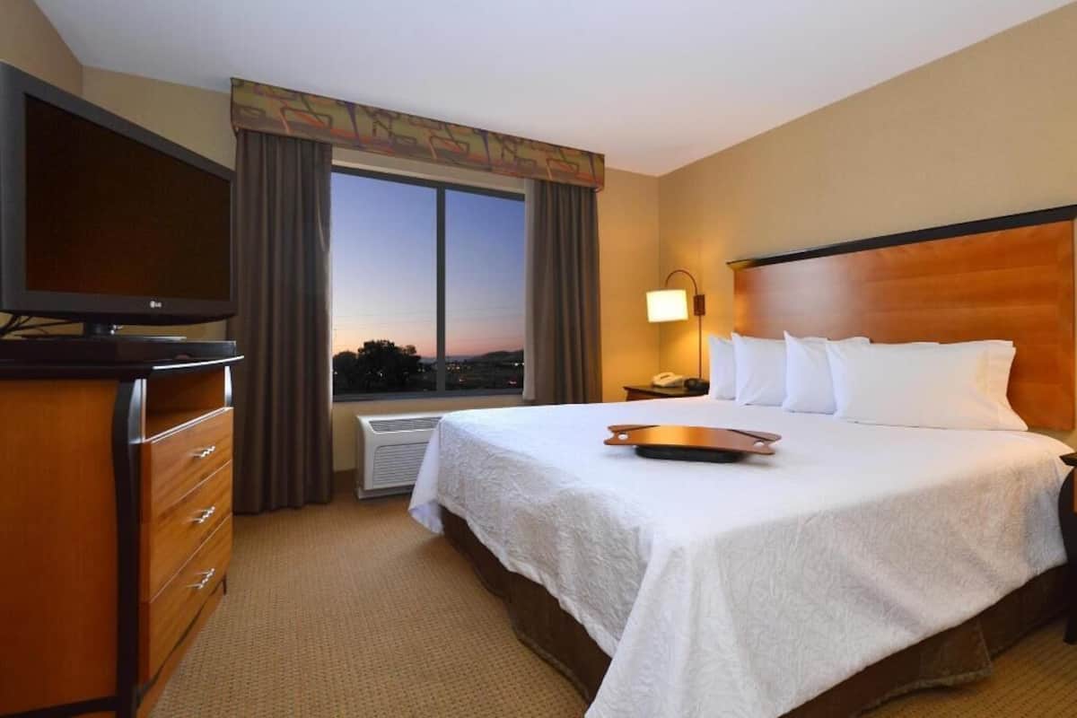 Hypo-allergenic bedding, desk, laptop workspace, blackout drapes