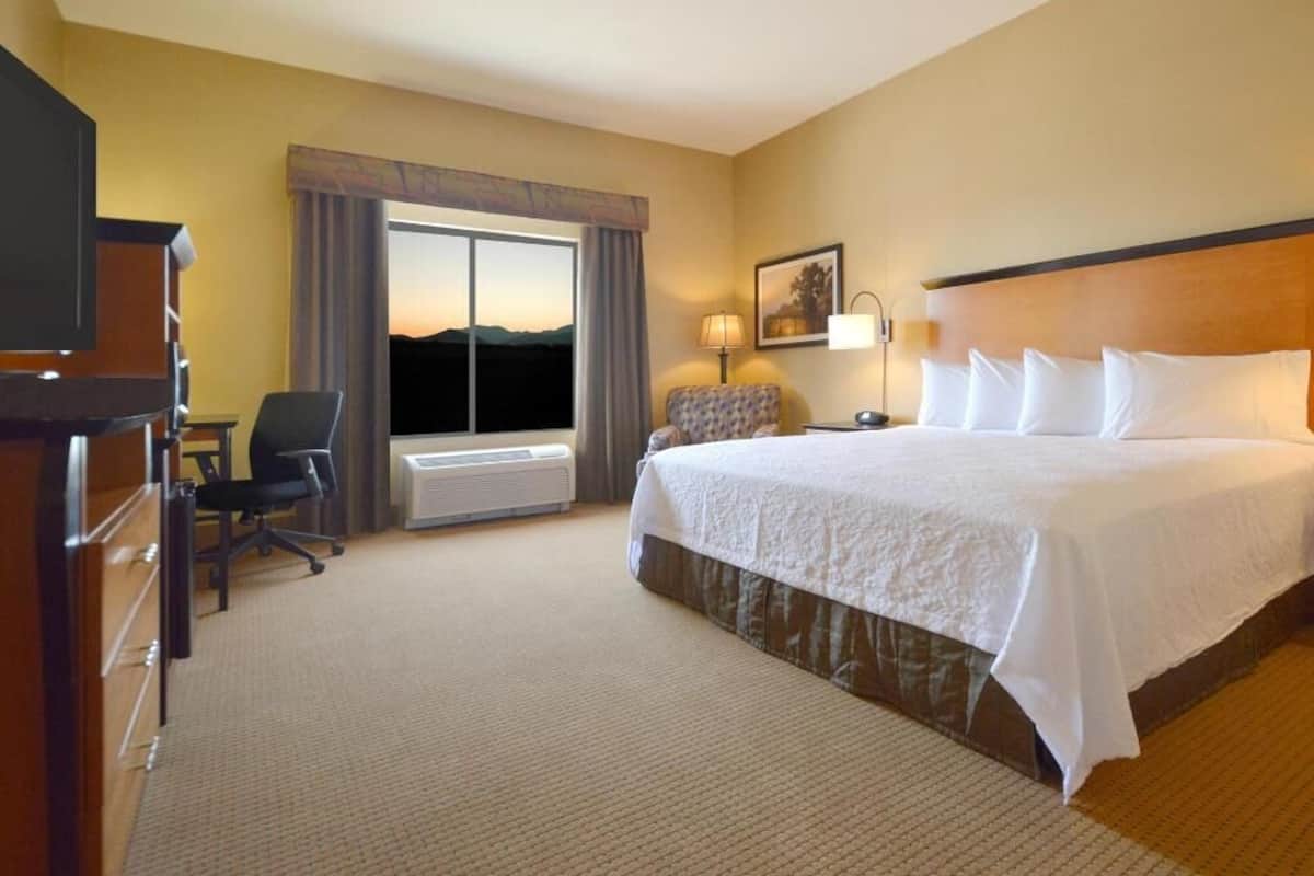 Hypo-allergenic bedding, desk, laptop workspace, blackout drapes