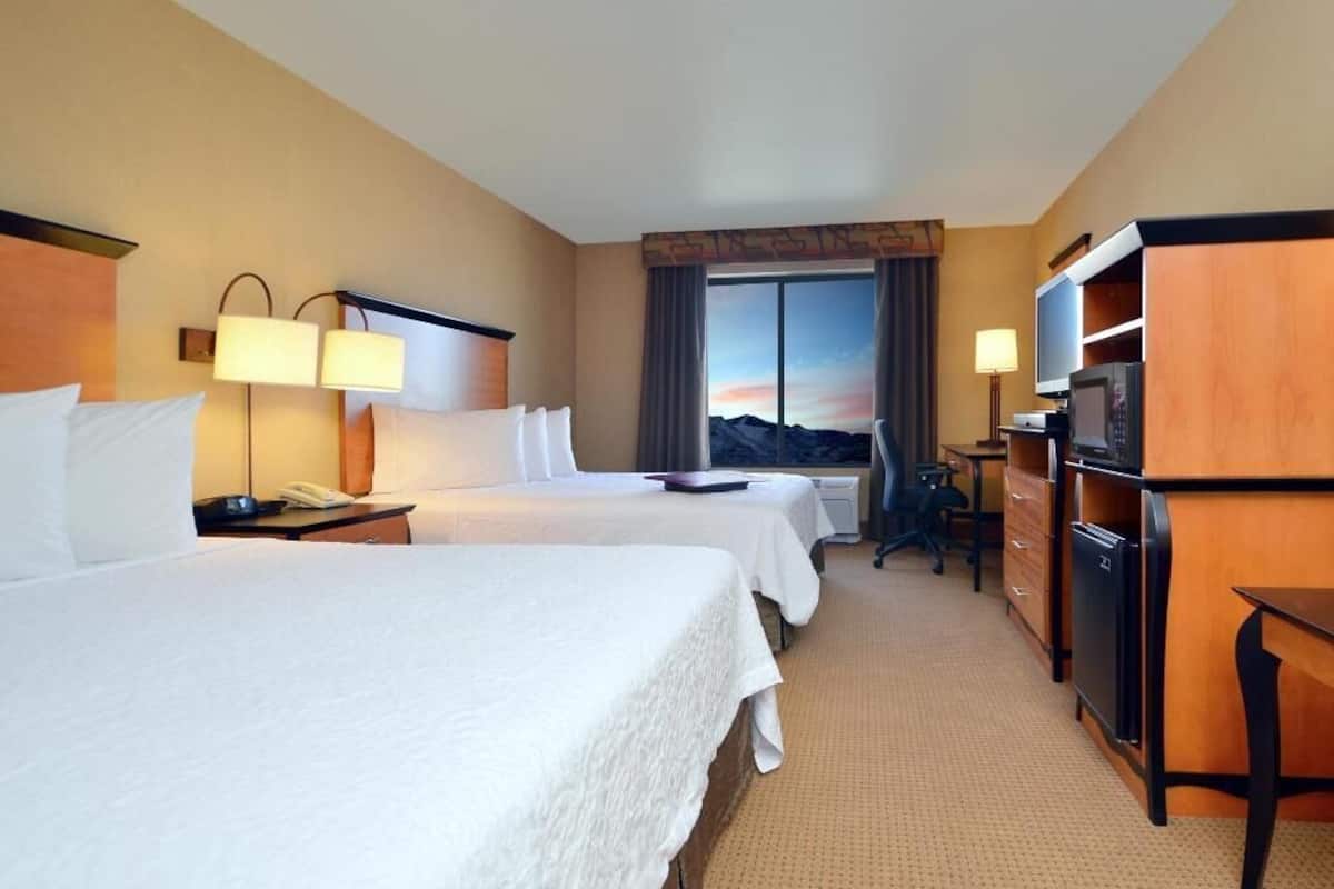 Hypo-allergenic bedding, desk, laptop workspace, blackout drapes