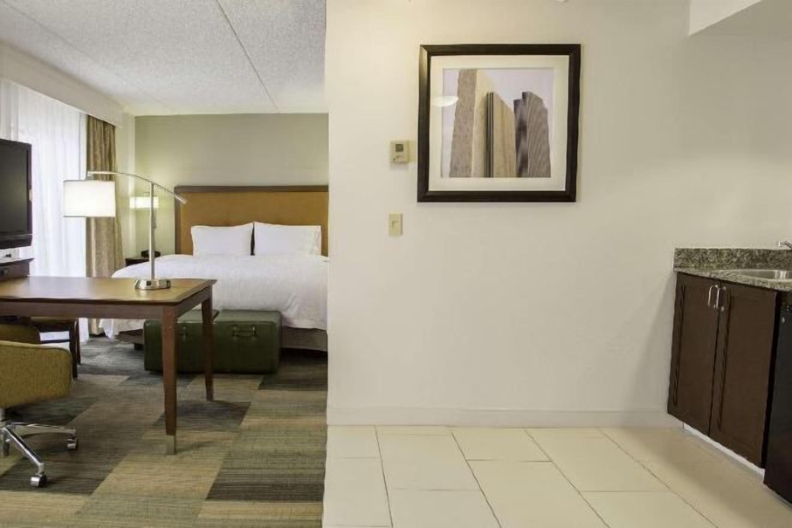 Premium bedding, desk, laptop workspace, blackout drapes