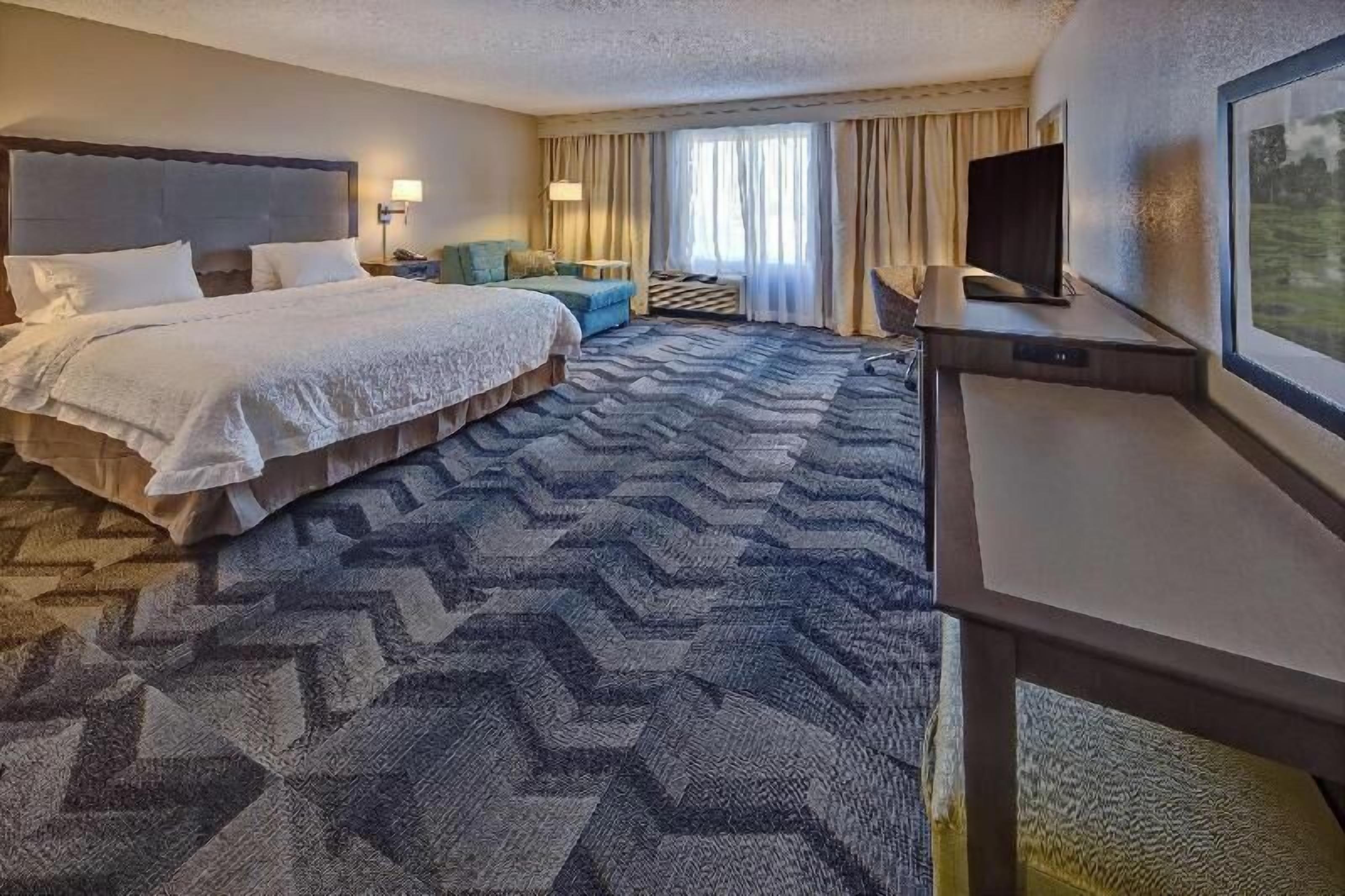 Premium bedding, desk, laptop workspace, blackout curtains