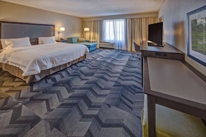 Premium bedding, desk, laptop workspace, blackout drapes