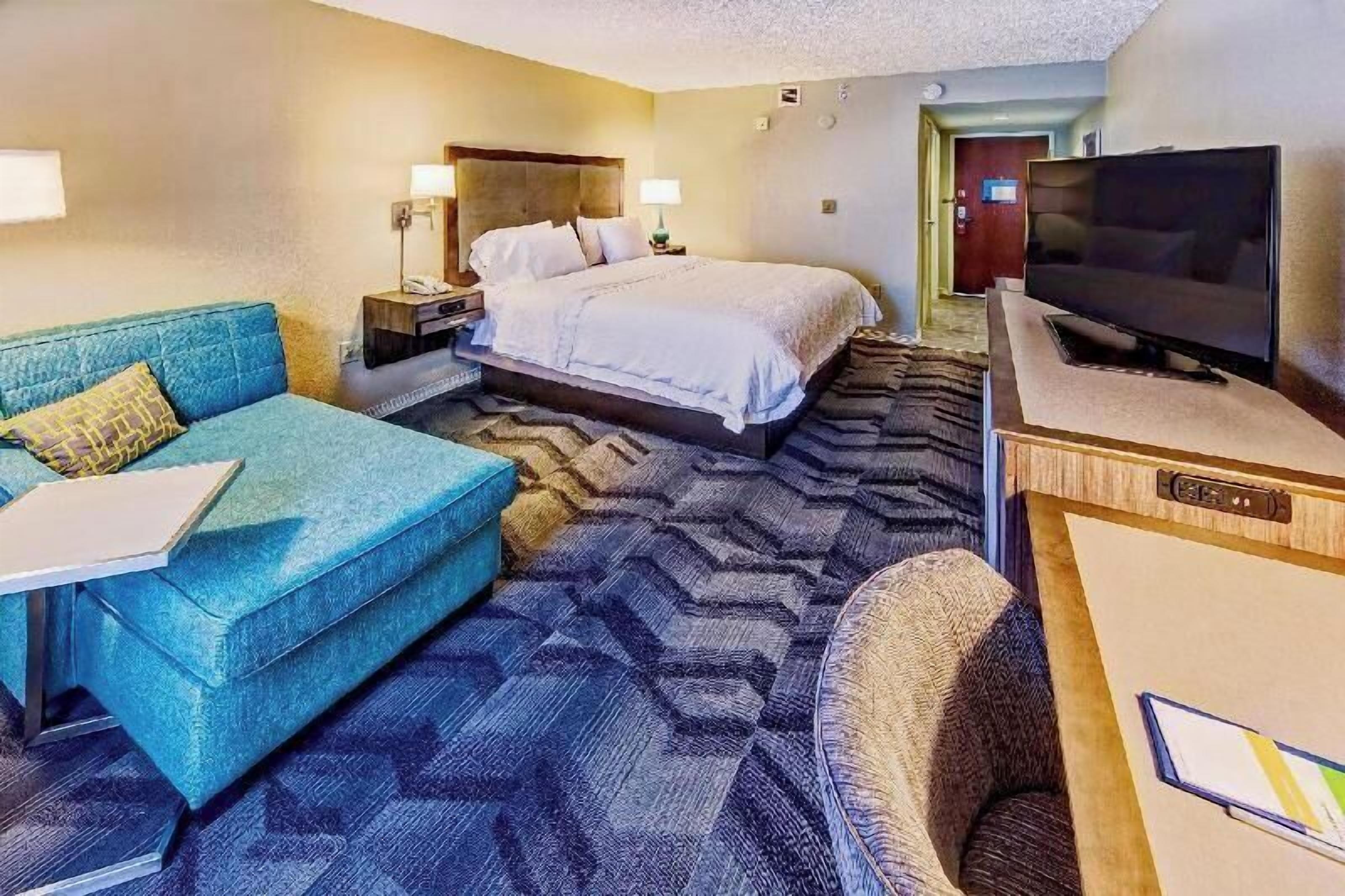 Premium bedding, desk, laptop workspace, blackout curtains