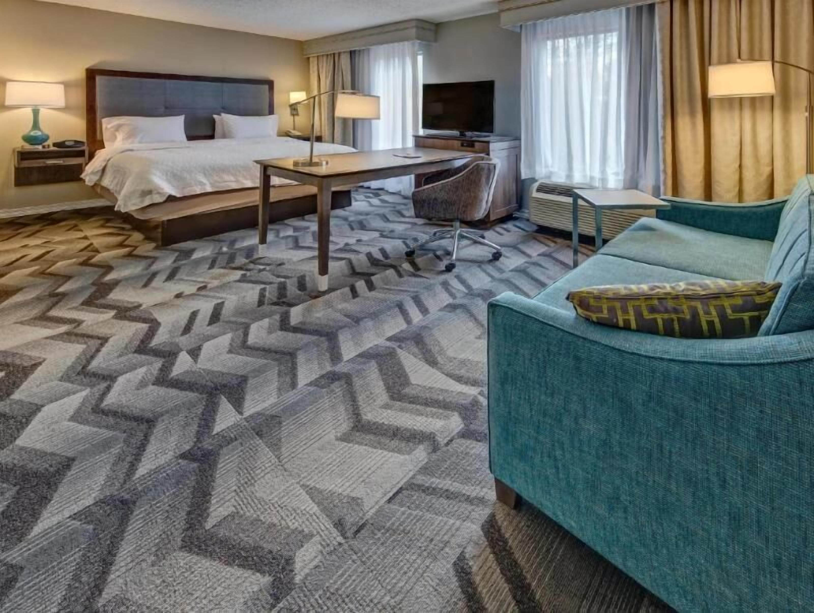 Premium bedding, desk, laptop workspace, blackout curtains