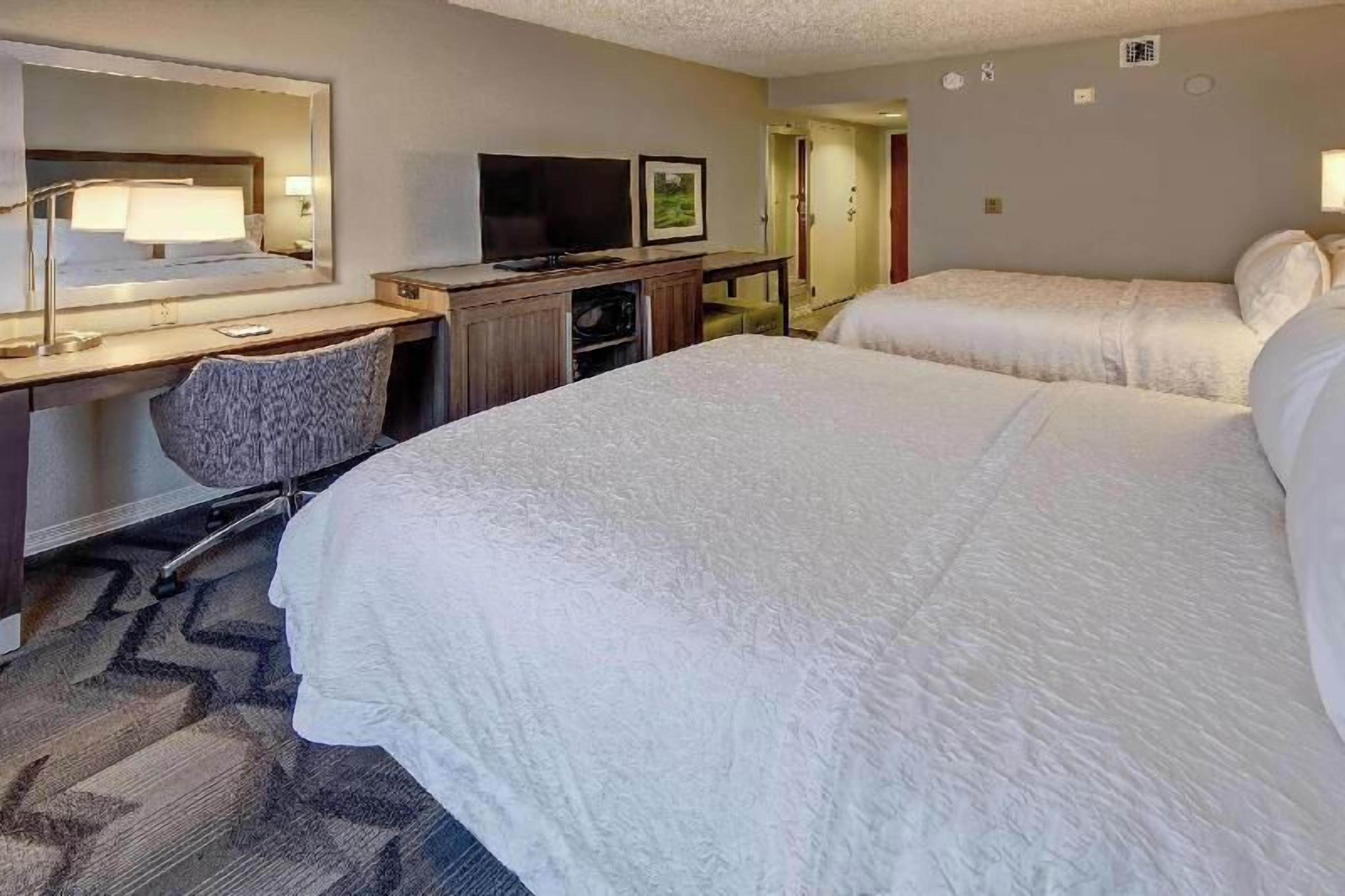Premium bedding, desk, laptop workspace, blackout curtains