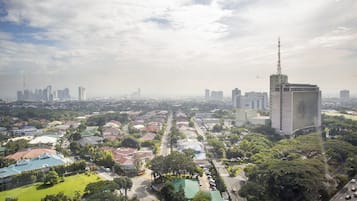 Panorama urbano con edifici residenziali, un grattacielo in evidenza e un’area verde di un parco.
