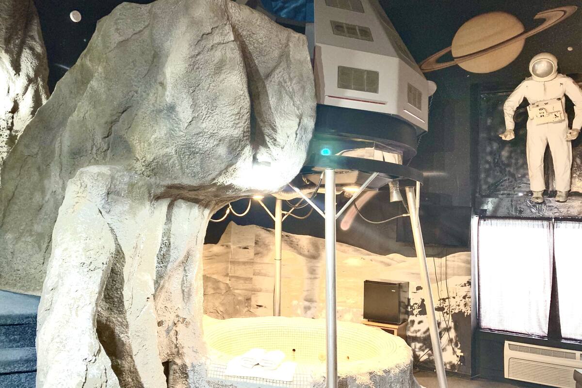 A space-themed exhibit with a model of a space station, a figure of an astronaut, and a planet model.