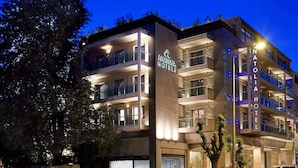 A modern hotel with multiple balconies, a prominent sign reading "Anatolia Hotels," and a well-lit facade. - Anatolia (Thessaloniki)