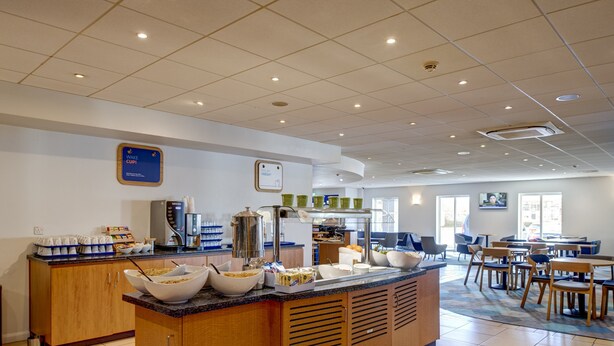 A breakfast buffet area with a variety of food options and seating arrangements. - Holiday Inn Express Newcastle Gateshead by IHG (Newcastle-upon-Tyne)