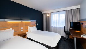 A hotel room with two beds, a desk, a television, and a window with curtains. - Holiday Inn Express Newcastle Gateshead by IHG (Newcastle-upon-Tyne)