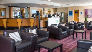 A hotel lobby with leather sofas, a reception desk, and a bar area. - Holiday Inn Express Newcastle Gateshead by IHG (Newcastle-upon-Tyne)